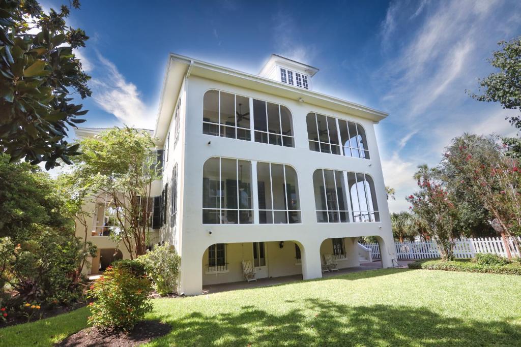 a large white building with a yard at Virginia Point INN in Galveston