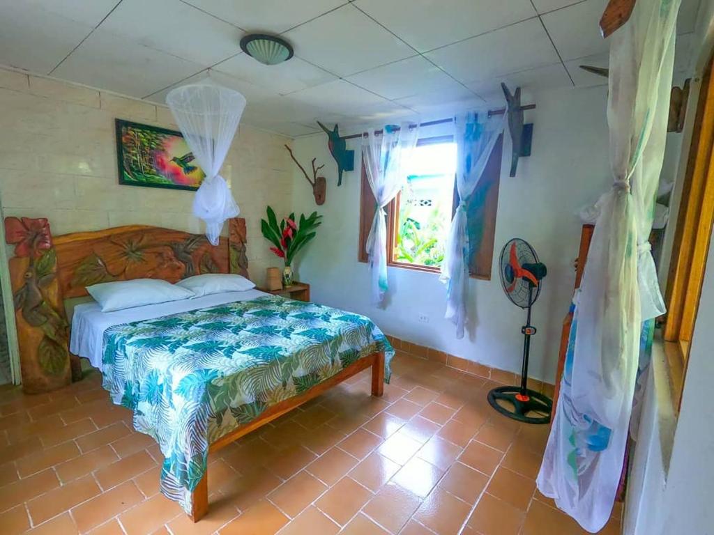 a bedroom with a bed and a dresser at Cabinas Tito in Cahuita
