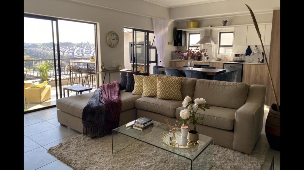 a living room with a couch and a table at Spectacular 2 bedroom Penthouse Apartment in Midrand