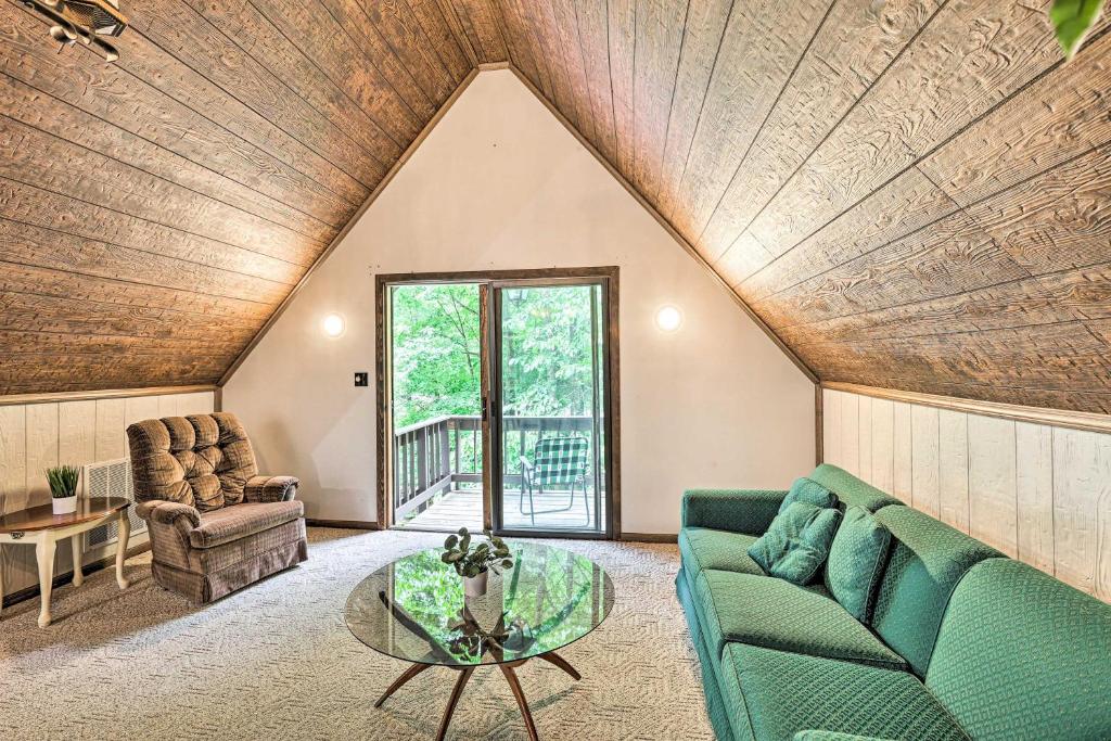 a living room with a couch and a table at Charming Roan Mtn Cabin Across from Creek! in Roan Mountain