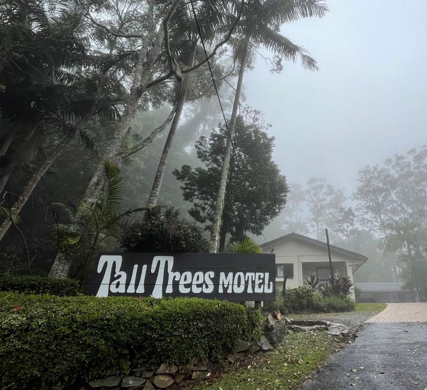 a sign that reads kill trees motel in front of a house at Tall Trees Motel Mountain Retreat in Mount Tamborine