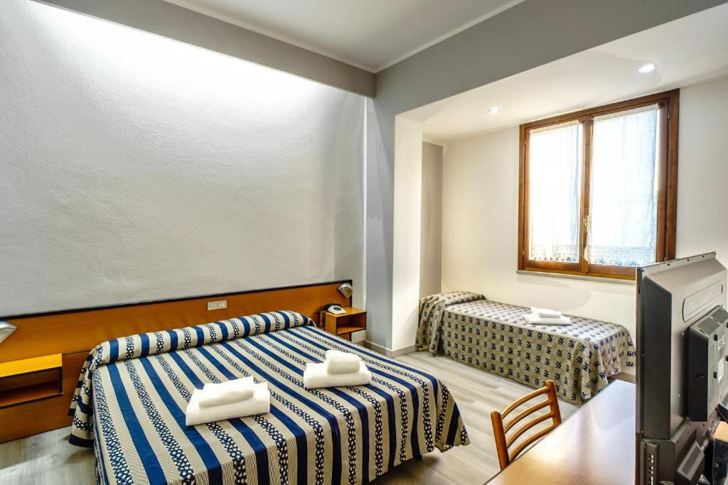 Postel nebo postele na pokoji v ubytování Albergo Martini