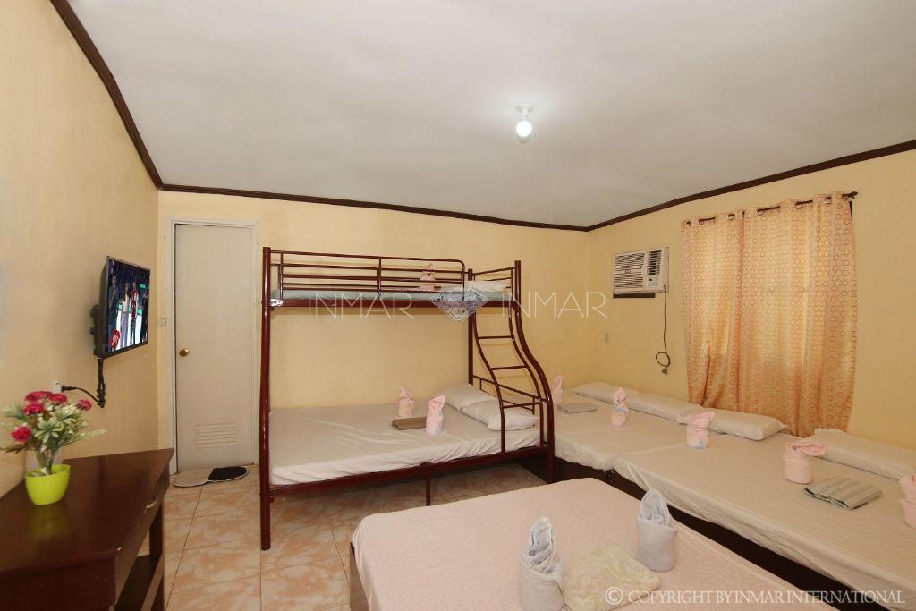 Postel nebo postele na pokoji v ubytování Ana Jean Lodging House