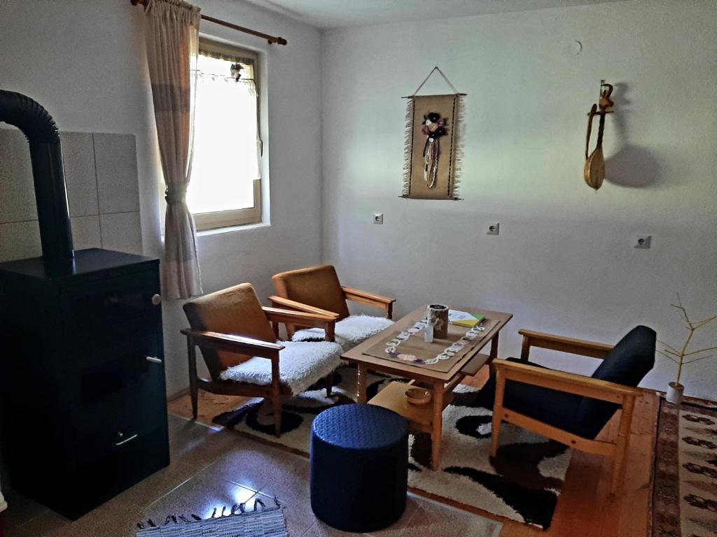 a living room with a table and chairs at Kosta's romantic house in Plav