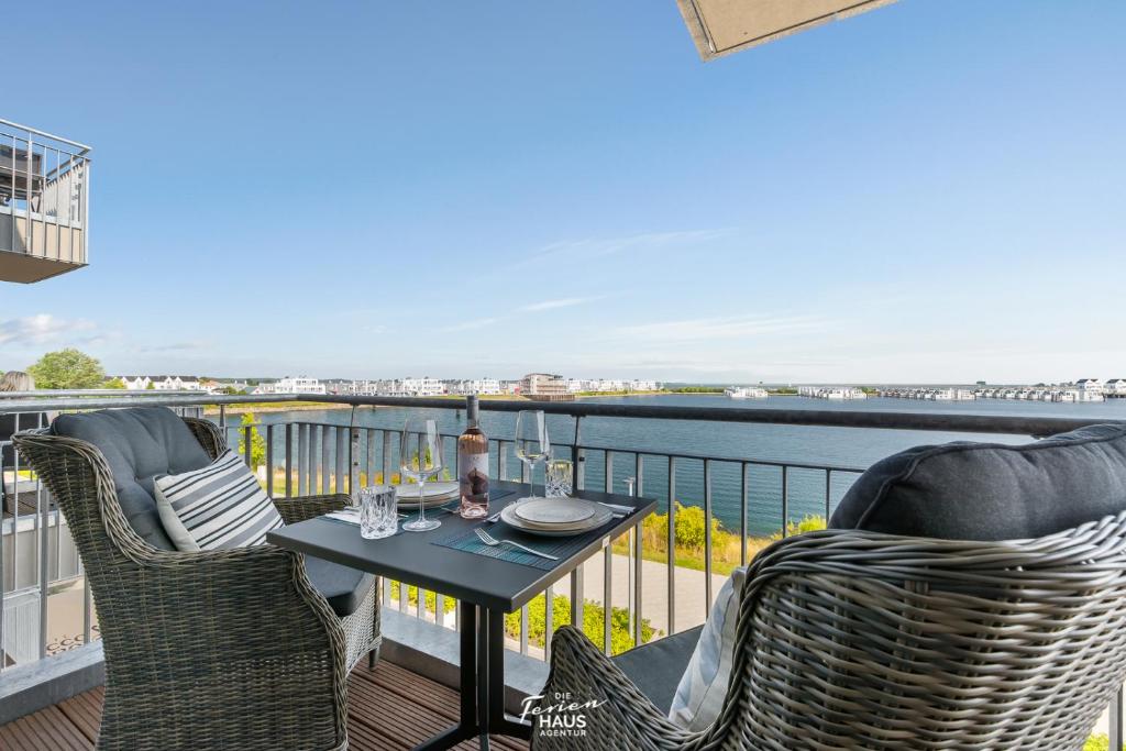 a patio with two chairs and a table on a balcony at Blue Horizon in Olpenitz