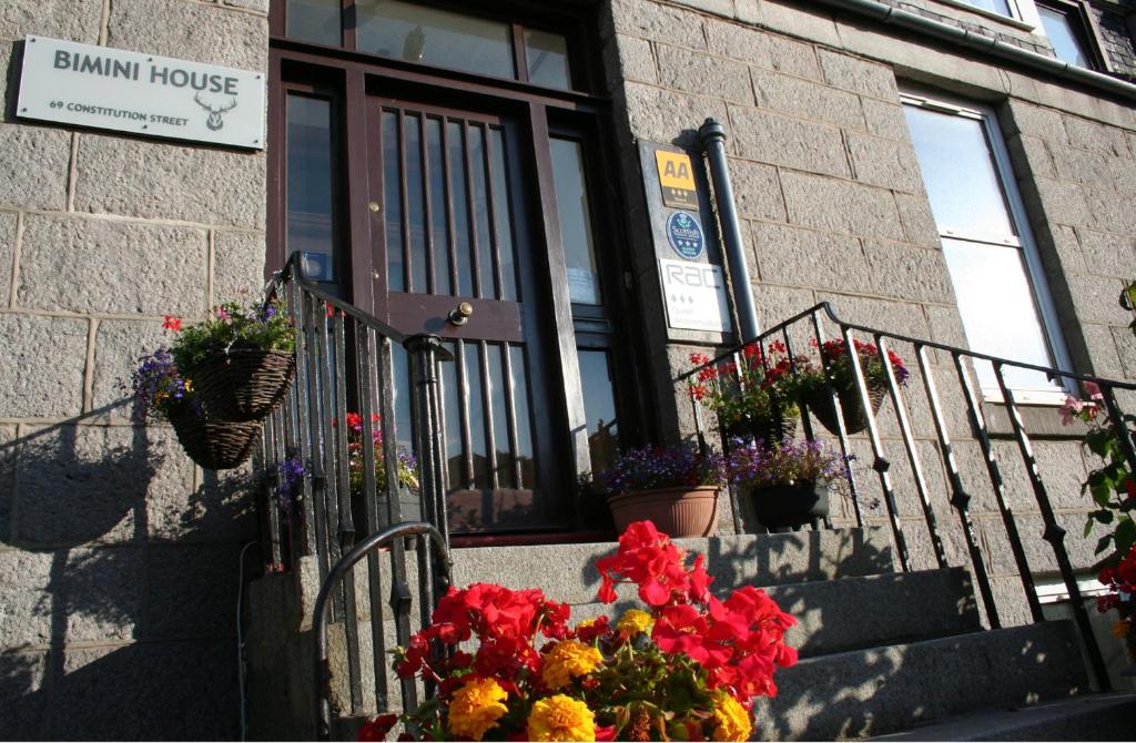 a bunch of flowers on the steps of a building at Bimini House in Aberdeen