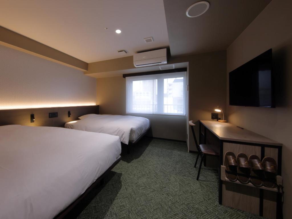 Postel nebo postele na pokoji v ubytování Hotel SUI Kobe Sannomiya by ABEST