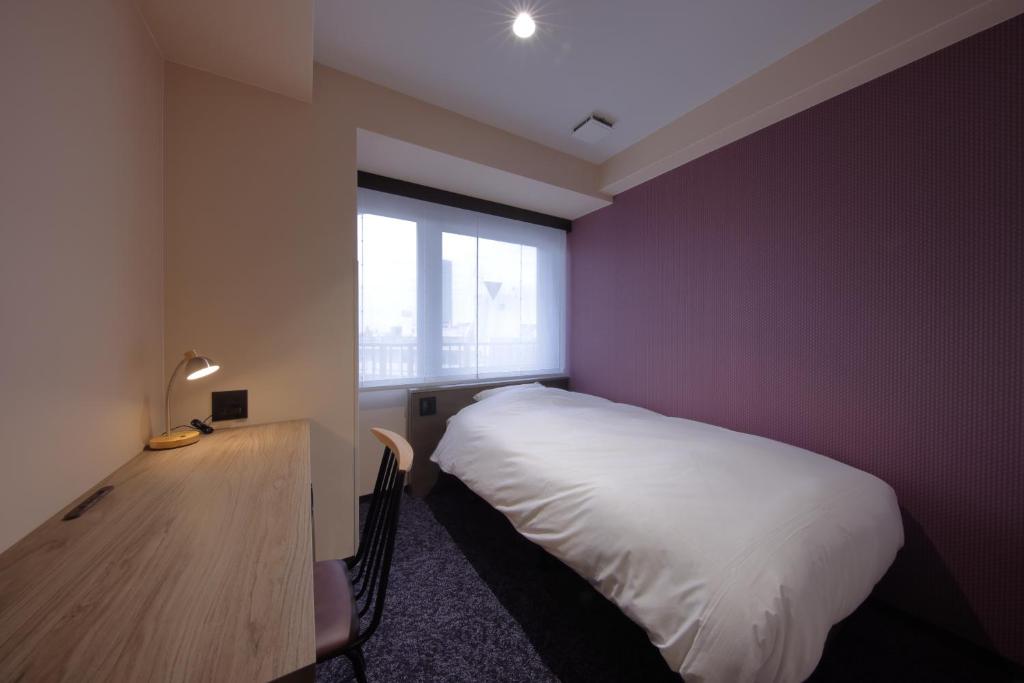 Postel nebo postele na pokoji v ubytování Hotel SUI Kobe Sannomiya by ABEST