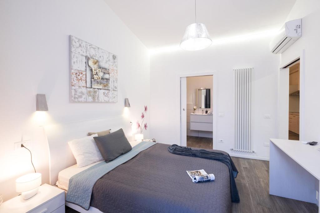 a white bedroom with a bed and a desk at Budapest Easy Flat Oktogon in Budapest
