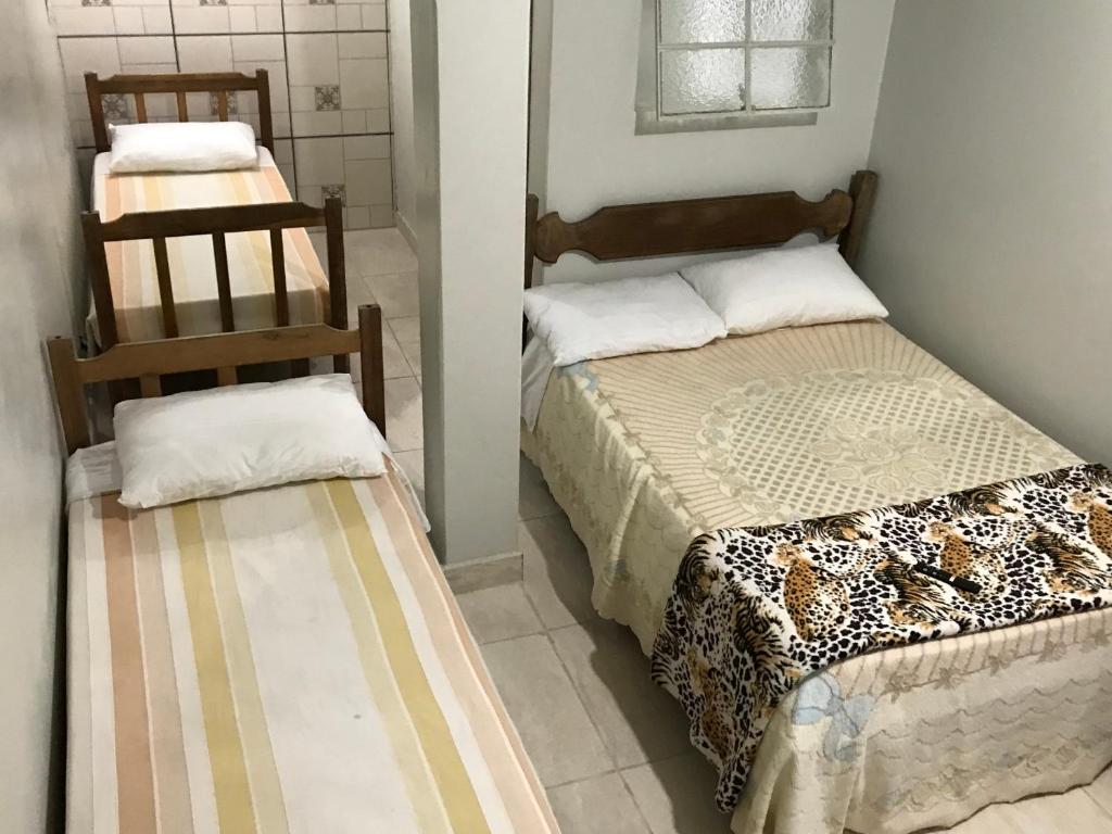 Un pat sau paturi într-o cameră la Pousada Acayaca