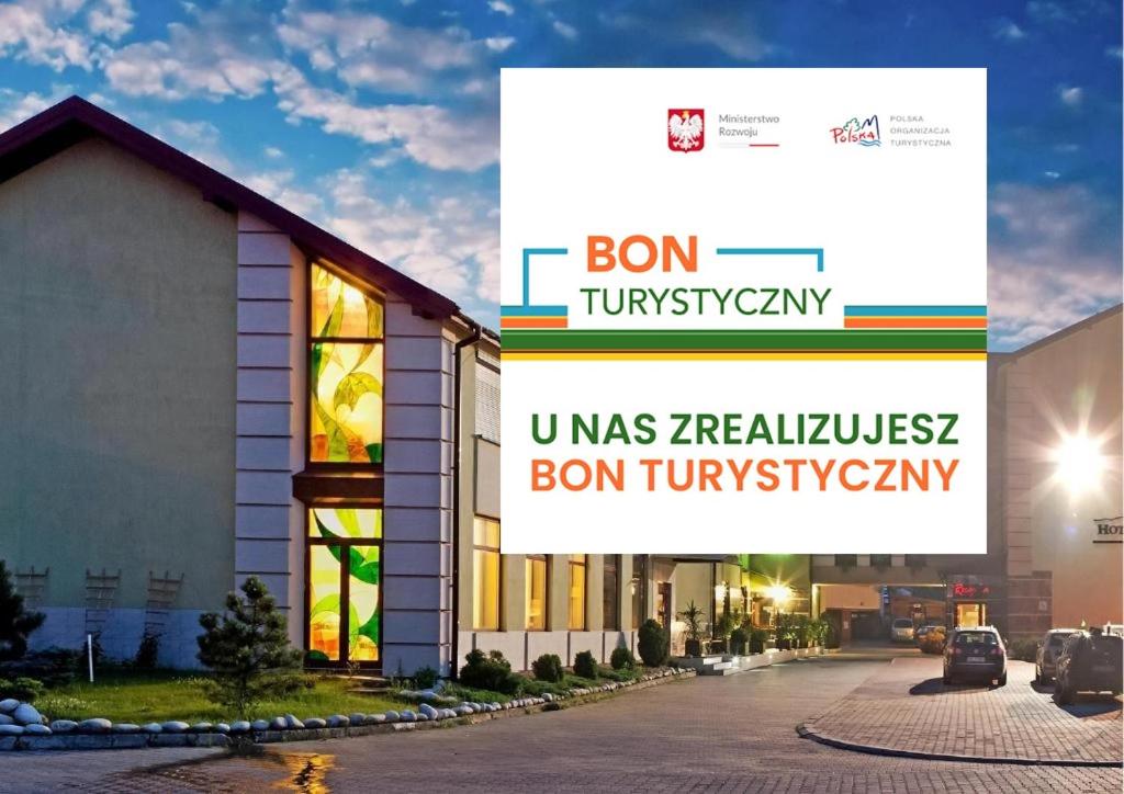 a building with a sign that reads bon tum university at Hotel City SM Business & Spa in Kraków