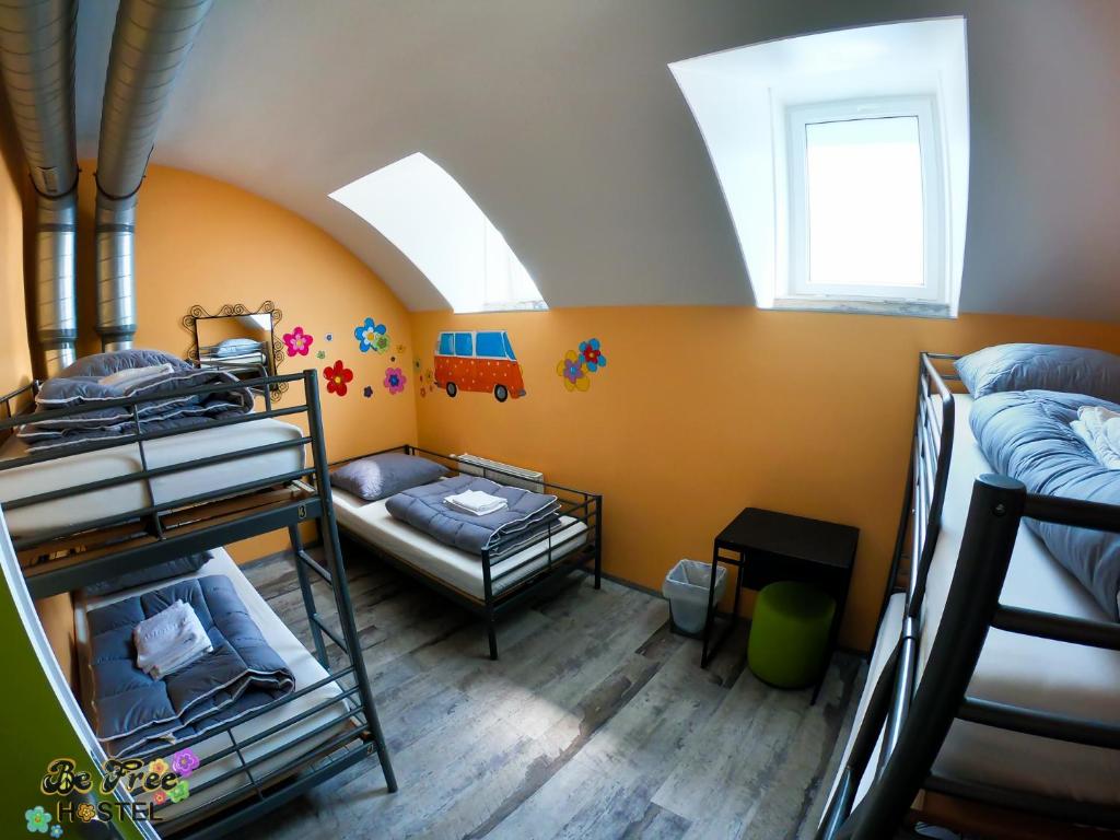 a dorm room with bunk beds and a window at BeFree Hostel - Self-Service in Vienna