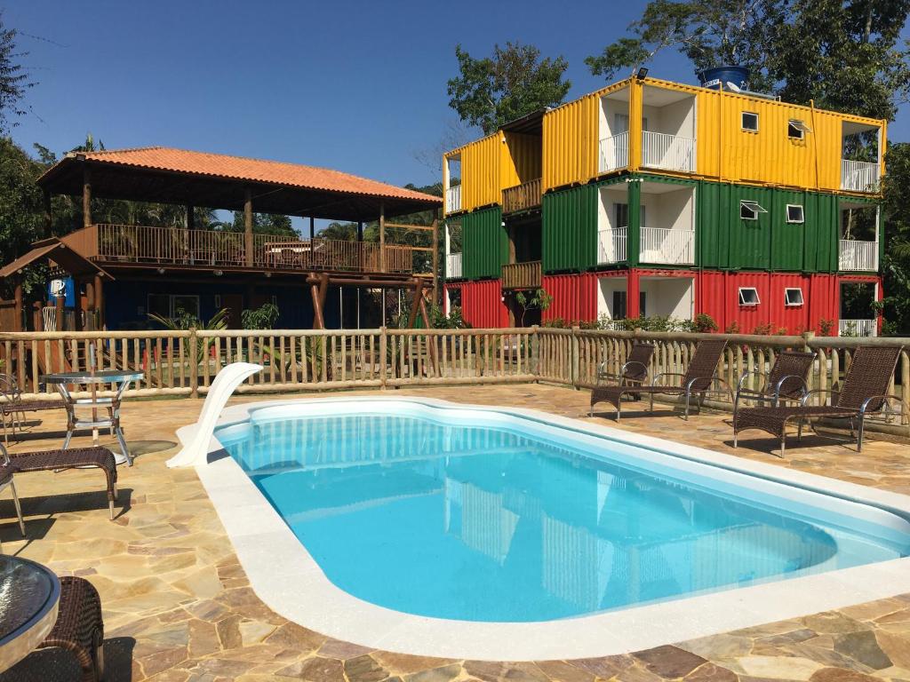 a swimming pool in front of a colorful building at Trakai Suites in Ubatuba