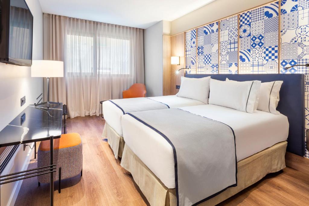 Cama o camas de una habitación en Eurostars Guadalquivir