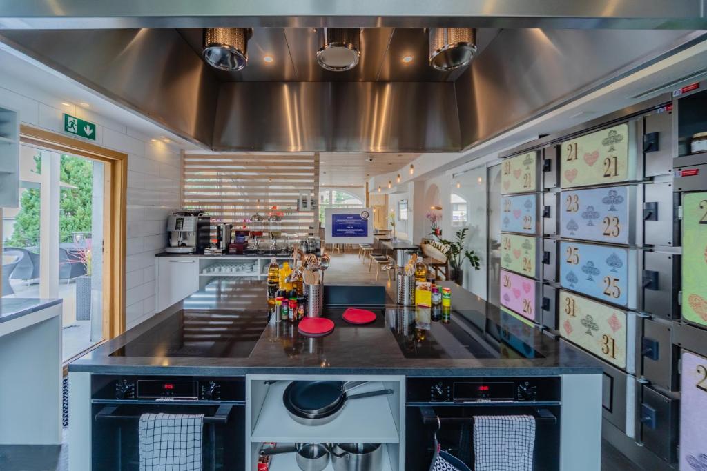 a kitchen with stainless steel appliances and stainless steel appliances at GRAND Your home with common kitchens in Engelberg