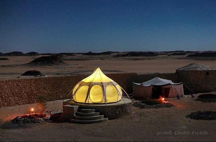 a tent in the middle of the desert at night at Al Nyhaya in Siwa