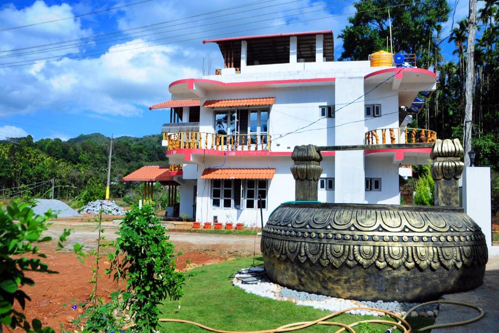a house with a large tire in front of it at DELIGHTFUL HOMESTAY in Sollebail