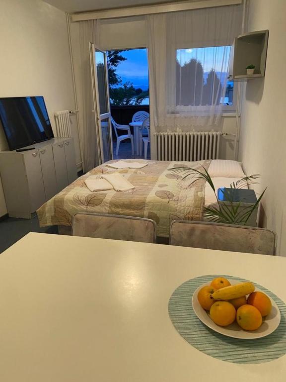 a room with a table with a plate of fruit on it at Apartmán s terasou in Senec