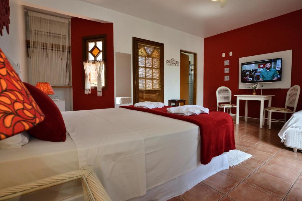 A bed or beds in a room at Pousada Fruto do Mar