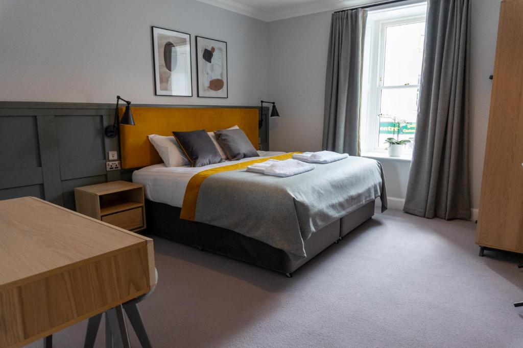 een slaapkamer met een bed en een raam bij Airds Apartments in Oban