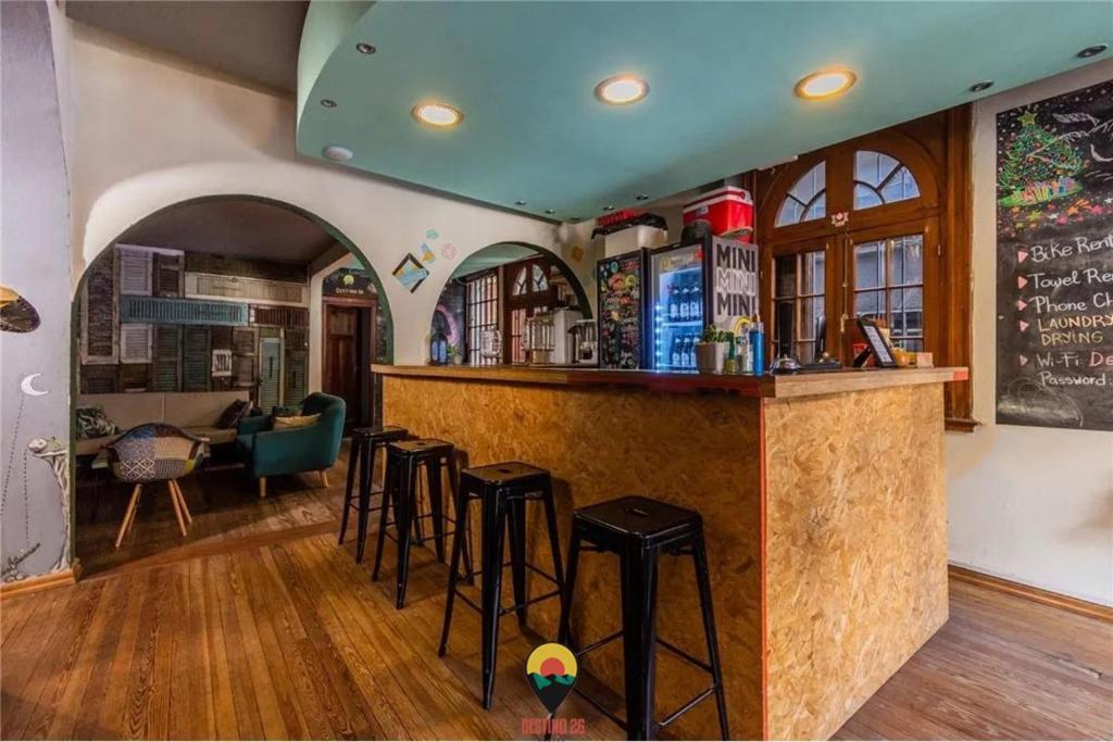 a bar in a restaurant with stools at a counter at Destino26 Hostel in Montevideo