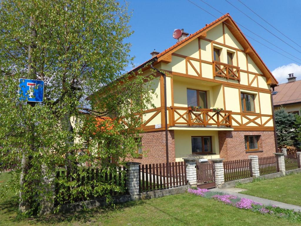 a house with a fence in front of it at Demänova 238 in Liptovský Mikuláš