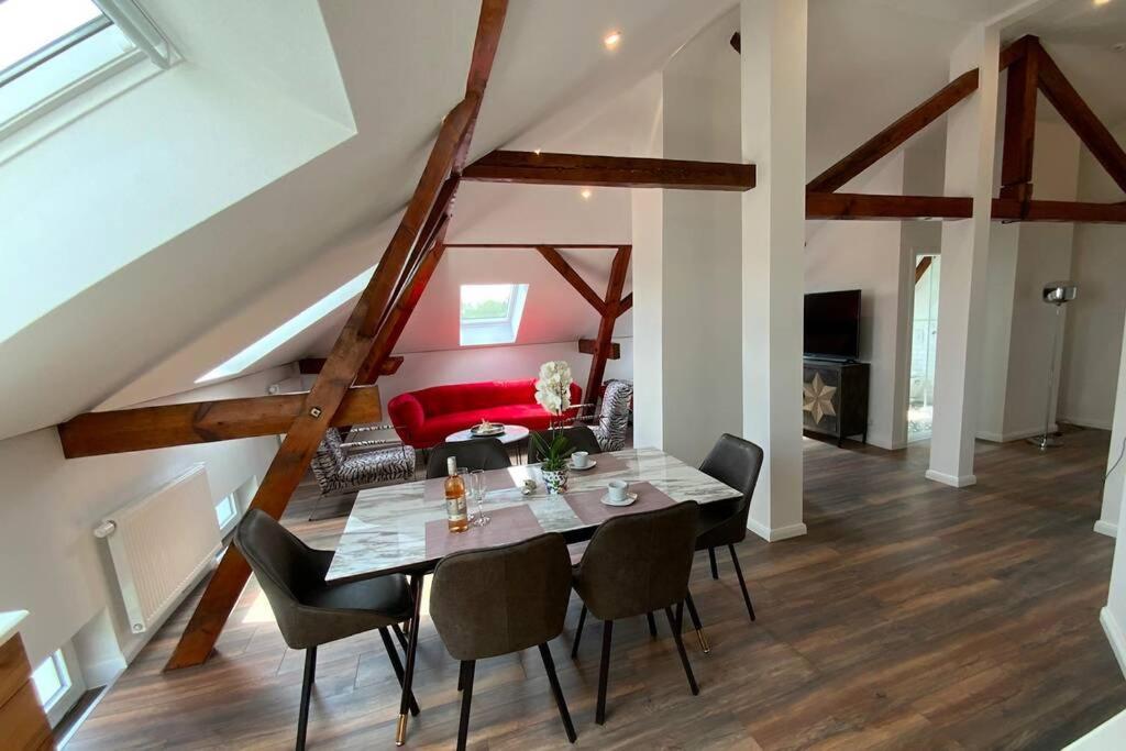 a dining room with a table and chairs at Ferienwohnung Loft 1 in Varel