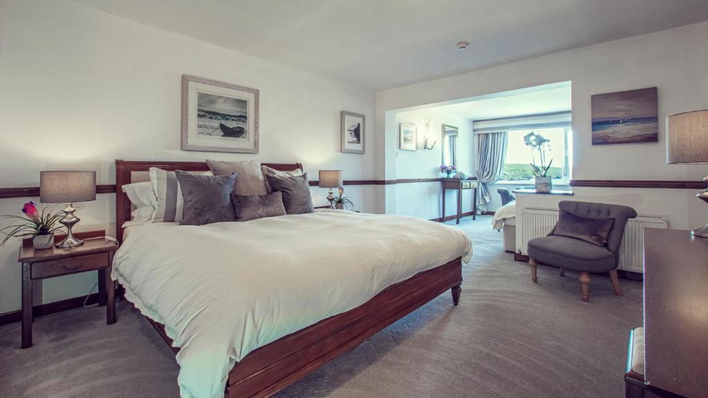 a large bedroom with a large bed and a desk at Ardagh Hotel & Restaurant in Clifden