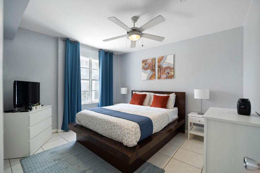 una camera con letto e ventilatore a soffitto di The Madison South beach Suites a Miami Beach