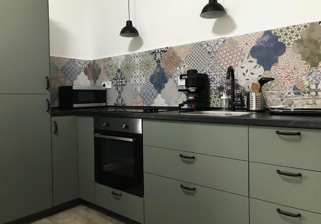 a kitchen with a sink and a counter top at Majorka in Tiszafüred