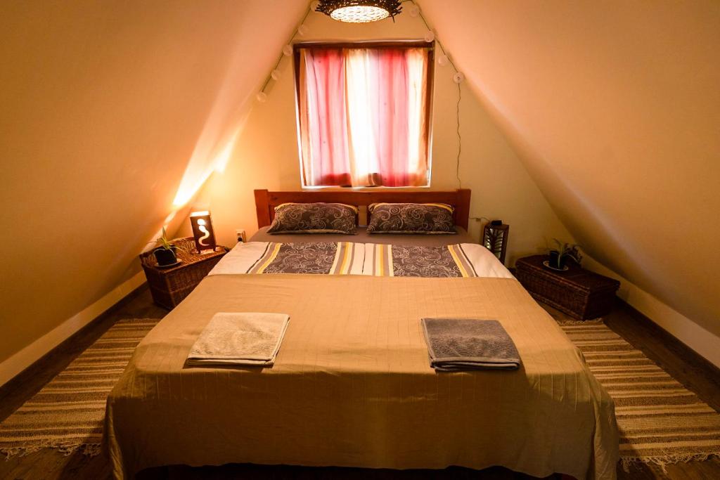 A bed or beds in a room at FAnima vendégház