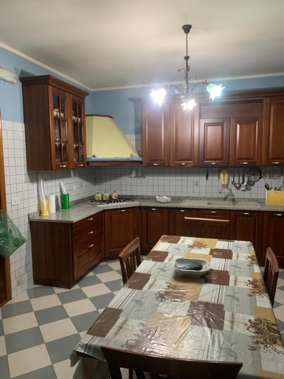 a kitchen with a table with chairs and a counter at B&B arpaia in Arpaia
