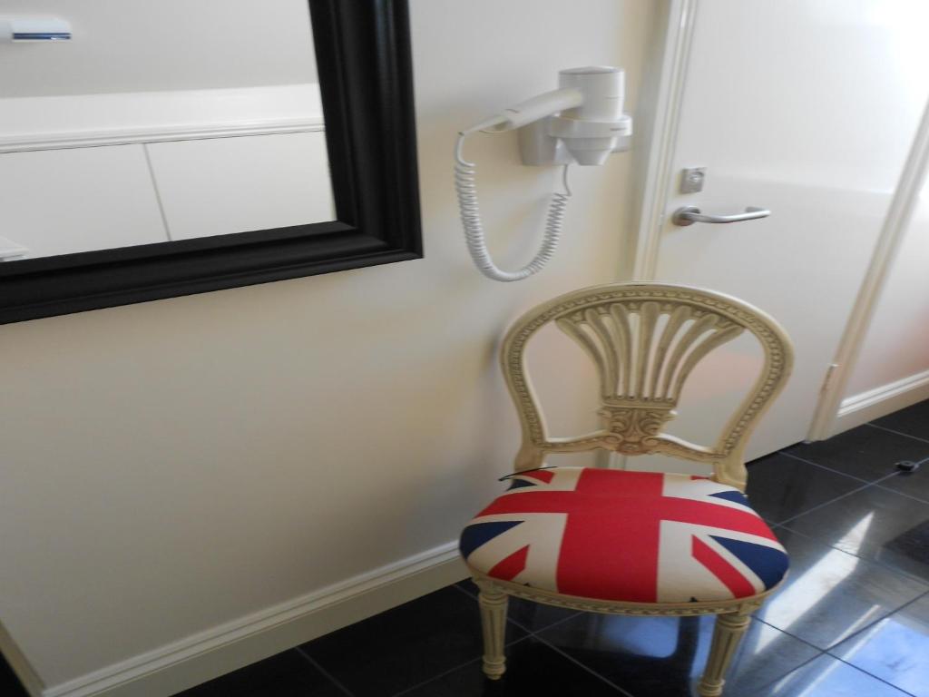 a room with a phone and a chair with a phone at 247London Studio Flats in London