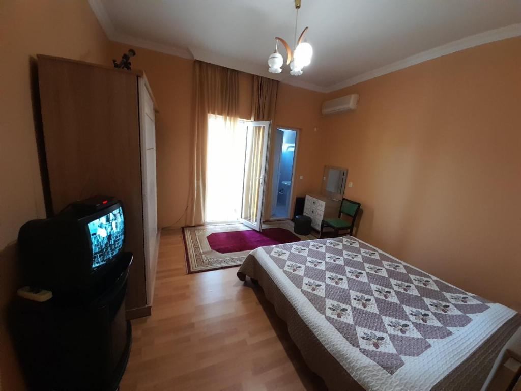 a bedroom with a bed and a tv in it at Kemeni Gardens in Batumi