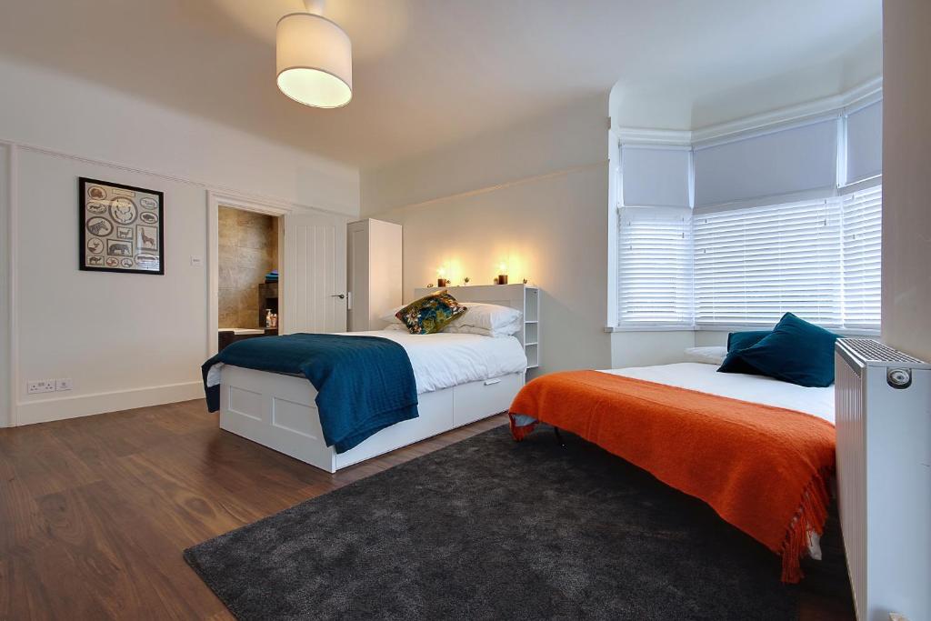 a bedroom with two beds and a window at Large En-suite by the Beach in Bournemouth
