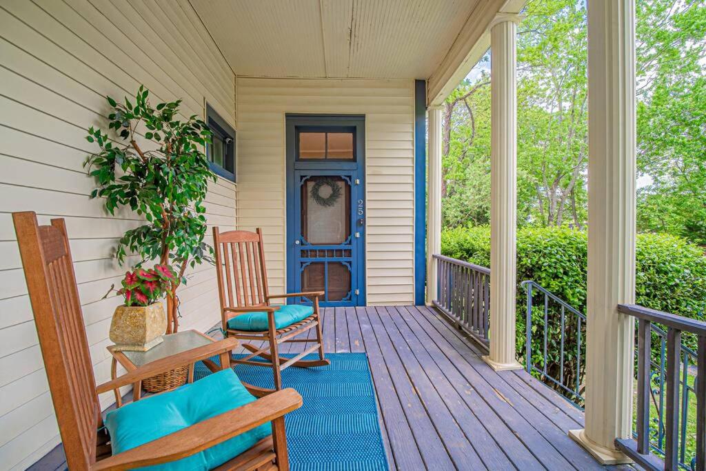 a porch with two chairs and a blue door at Historic Tate House Apartment by Marietta Square in Marietta