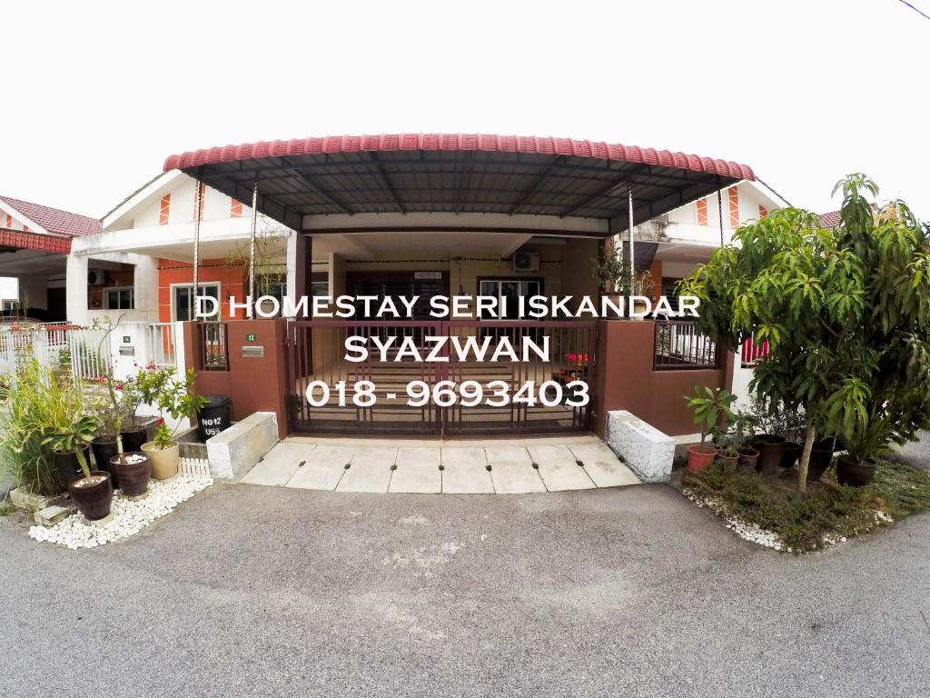 a house with a sign on the front of it at D HOMESTAY SERI ISKANDAR in Seri Iskandar