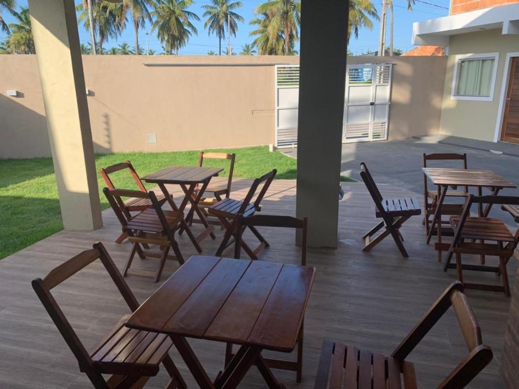 a group of tables and chairs on a patio at Atalaia Suítes in Salinópolis