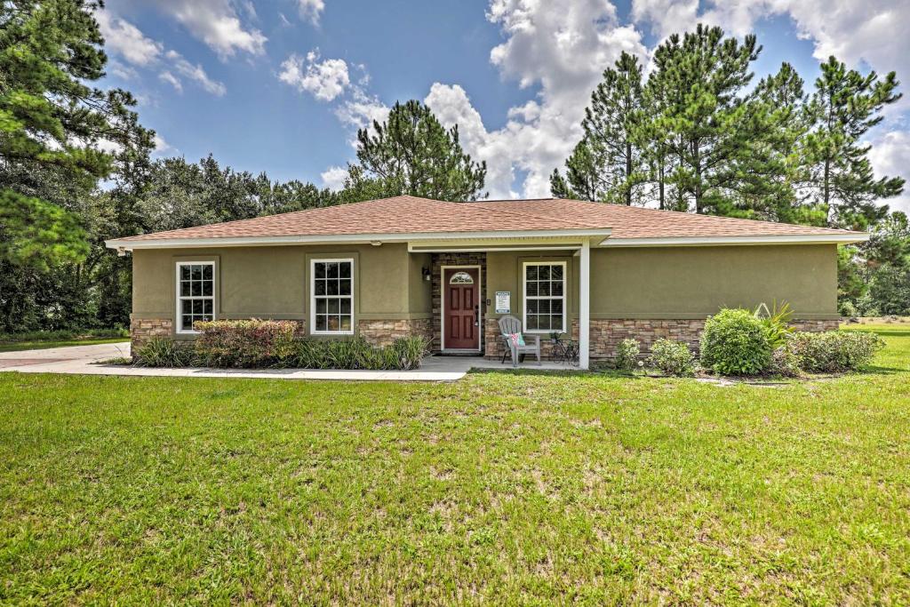 a small house with a lawn in front of it at Cozy Ranch Home with Patio on St Johns River! in Palatka