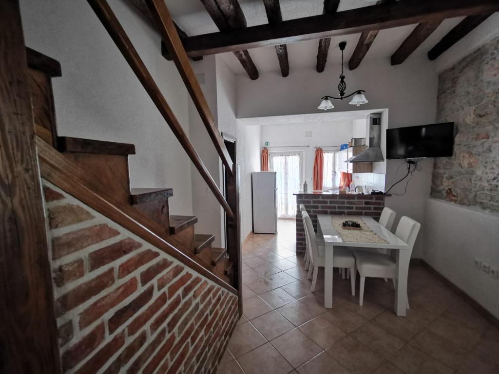 a kitchen and dining room with a table and a staircase at Apartments Relax Zone in Umag