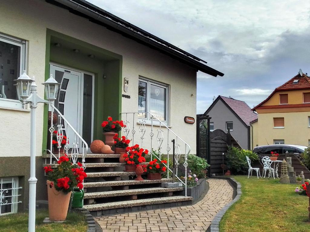 a house with flowers on the stairs of a house at Haus Heidrun in Dolgesheim