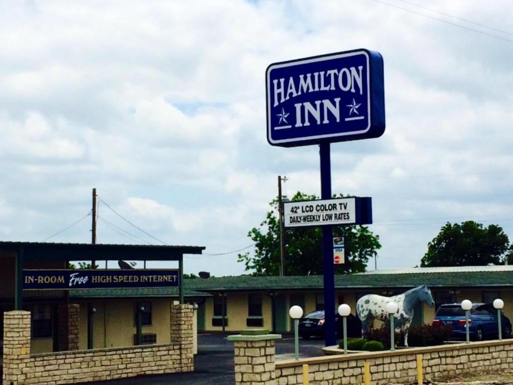 a sign for a hamilton inn in front of a building at Hamilton Inn in Hamilton