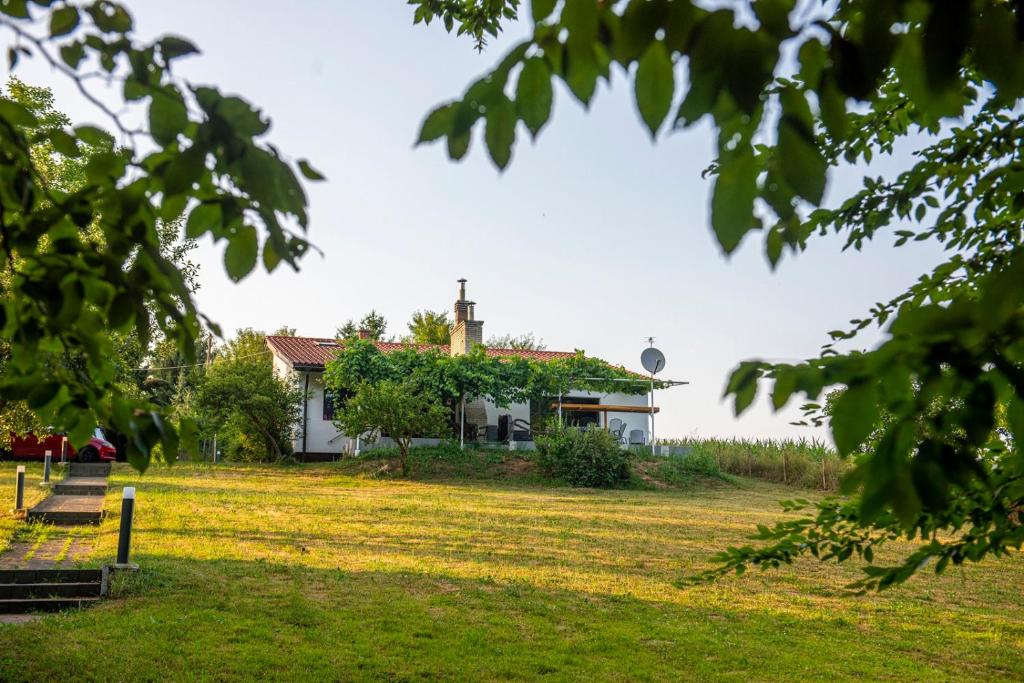 a house in the middle of a grass field at Villa Mira Zagreb in Kraljevec Kupinečki