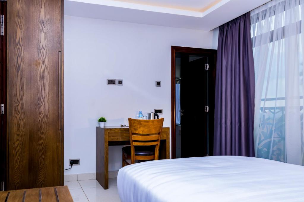 Postel nebo postele na pokoji v ubytování Canary Hotel Kampala