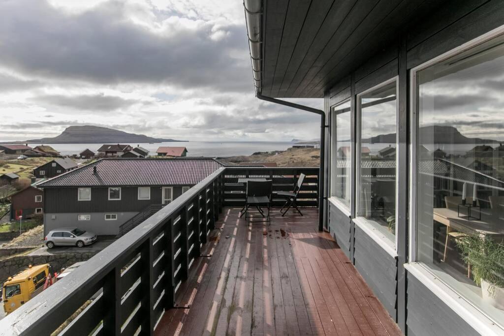 a balcony with a view of the ocean at FaroeGuide seaview villa and apartment in Tórshavn