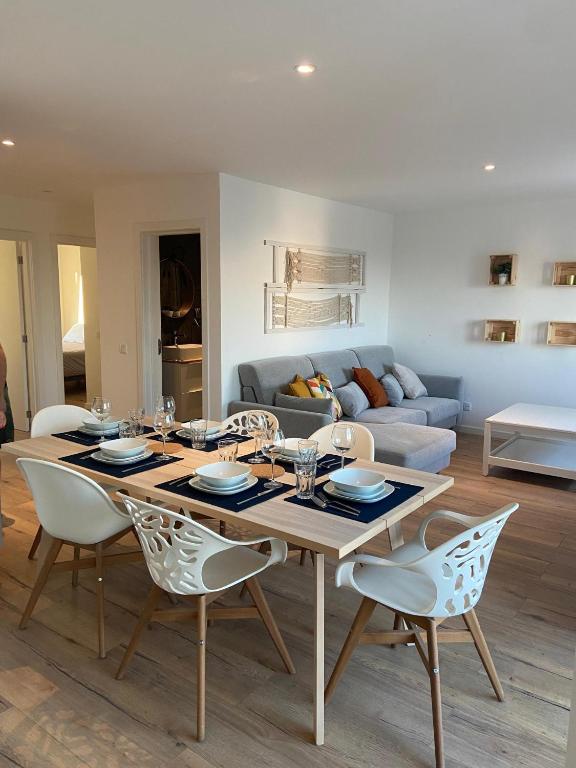 a living room with a wooden table and chairs at Your Home @ Benagil in Lagoa