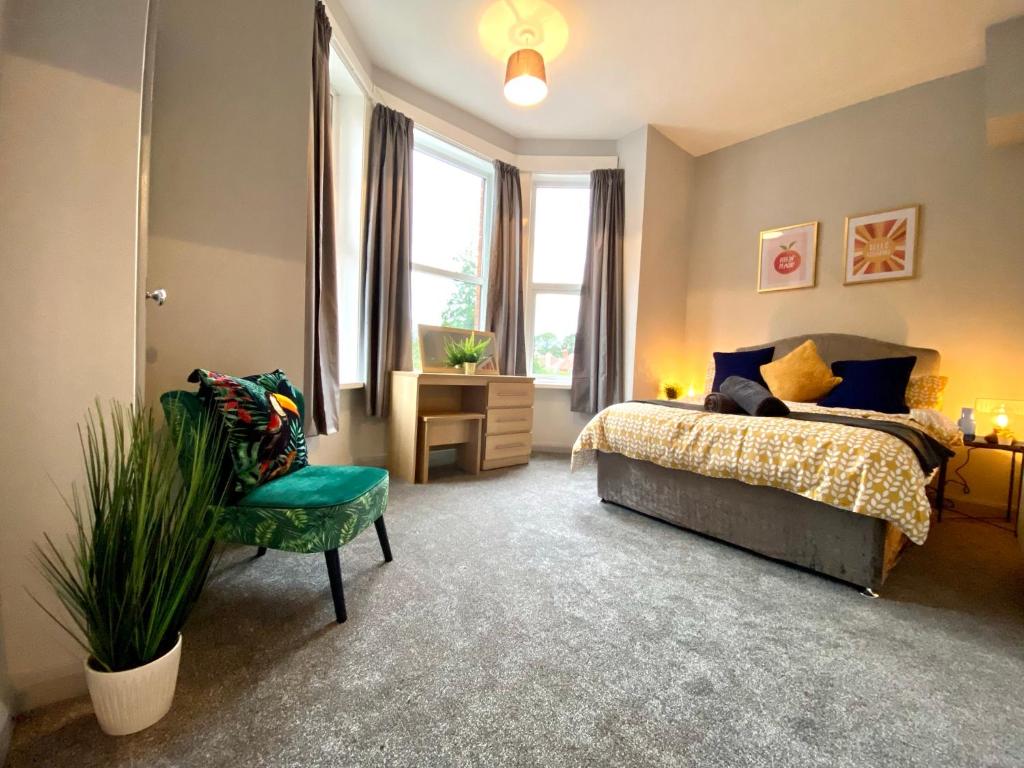 a bedroom with a bed and a chair at Funky Stylish Apartment! - 5 Minute Walk to the Best Beach! - Great Location - Parking - Fast WiFi - Smart TV - Newly decorated - sleeps up to 4! Close to Bournemouth & Poole Town Centre & Sandbanks in Bournemouth