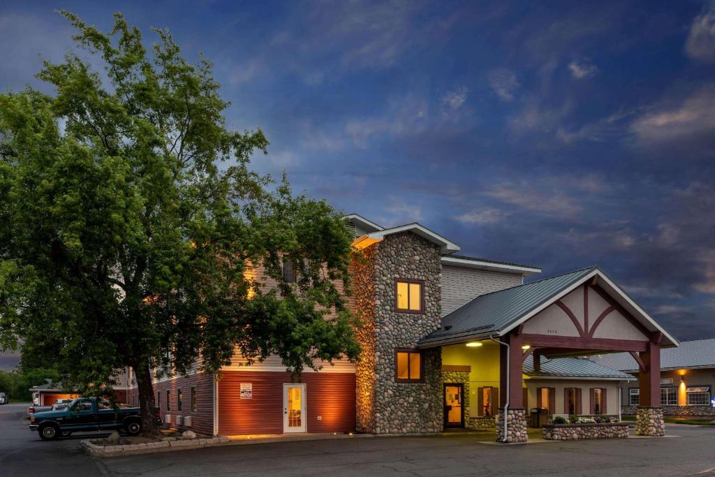 a building with a car parked in front of it at Super 8 by Wyndham Spokane Valley in Spokane Valley