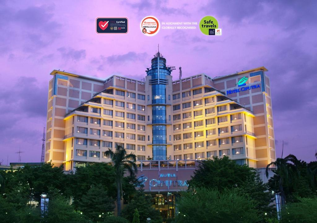 a large building with a clock tower in front of it at Hotel Ciputra Semarang managed by Swiss-Belhotel International in Semarang