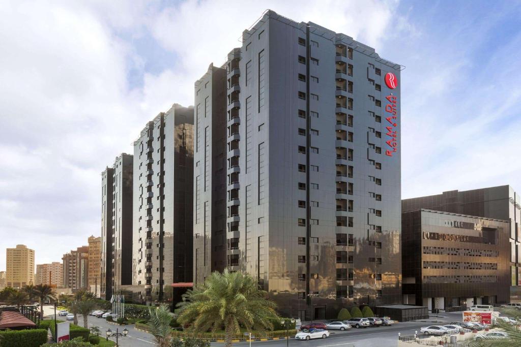 a large building with a large clock on it at Ramada Hotel & Suites by Wyndham Ajman in Ajman 